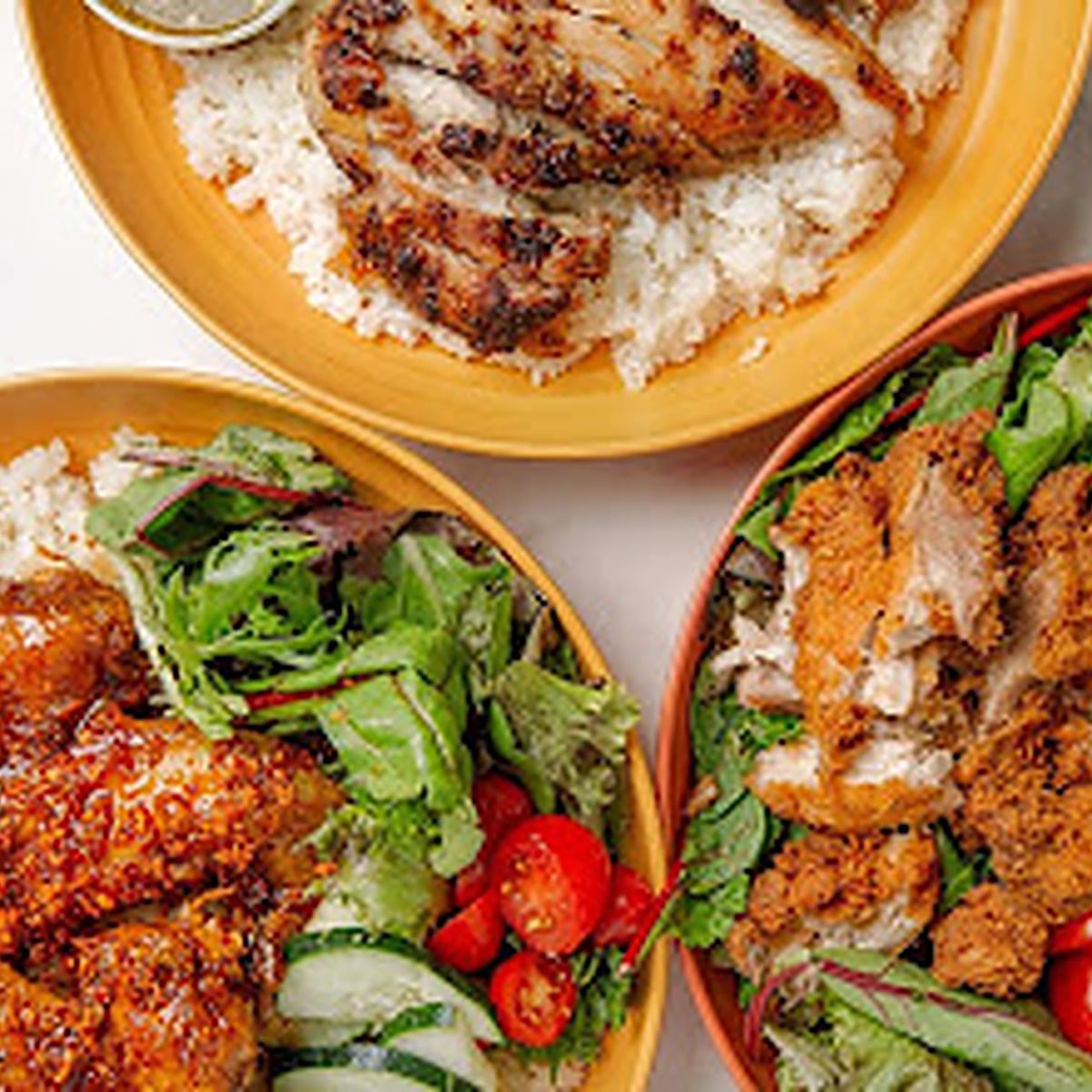 Rice bowls with grilled chicken, glazed chicken and fresh salad